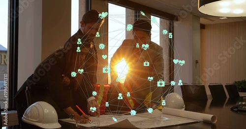 Reviewing 3 staff in suits with hivis vest leaning over plans helmets digital overlay in boardroom