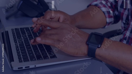 Mature man starting typing while working on office PC, fingers hovering, artifacts obscuring keys