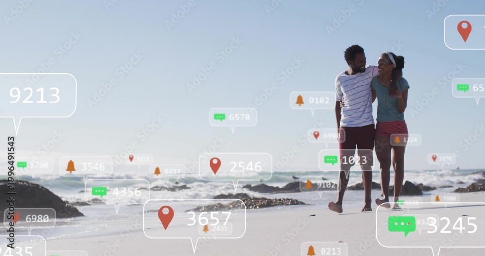 Obraz premium Walking couple in casual beachwear walking along wet sand on beach with digital markers, copy space