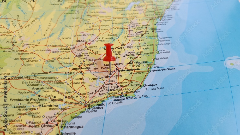 Obraz premium View of Divinopolis, is a municipality in the centre-west of Minas Gerais state, Brazil, on a geographical map of America, marked with red push pin