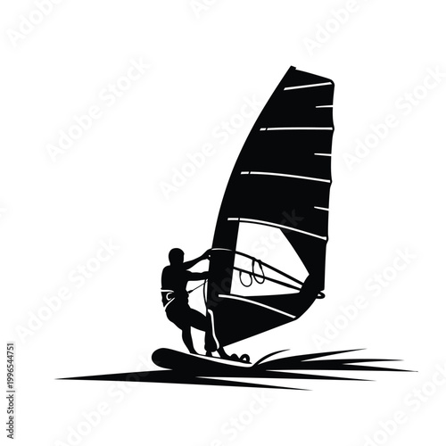 Silhouette of a skilled windsurfer riding fast across the blue water surface