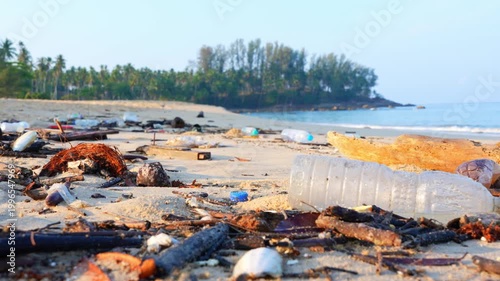 Plastic waste washed onto tropical beach reflects ocean contamination, consumer waste impacts, ecological vulnerability, and global efforts toward sustainability and pollution prevention. 4k.
