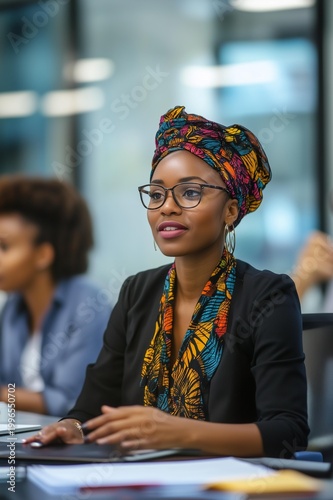 African businesswoman discssing work with her team i an office workspace