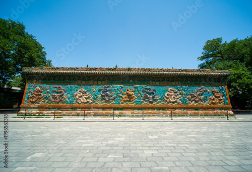 Beijing Beihai Park's Nine-Dragon Wall was built in the 21st year of the Qianlong reign of the Qing Dynasty (1756). It is a colored glazed brick shadow wall in a wooden structure imitation style.