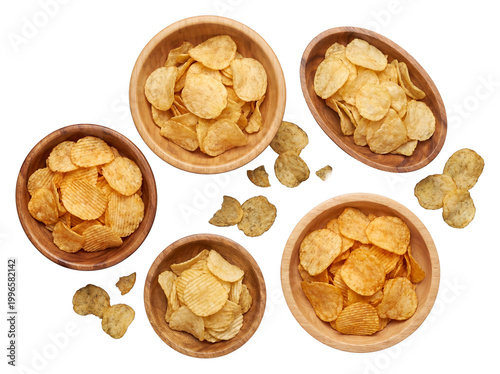 Assorted potato chips in various wooden bowls, including ruffled and plain varieties, with scattered chips.