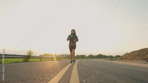 Teenage Girls running in country road.
