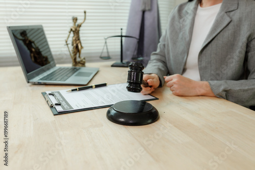 Vászonkép Close-up of an attorney's hand gripping a judge's gavel, representing decisive legal action and determination for justice