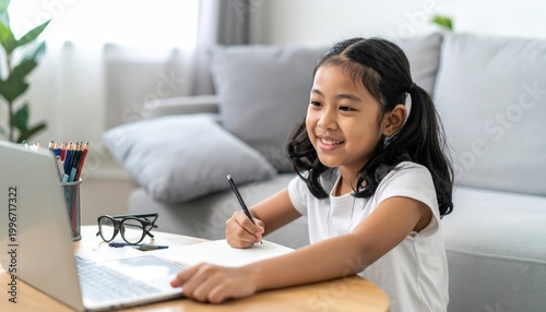 Young girl engaging in online learning at home with laptop.
