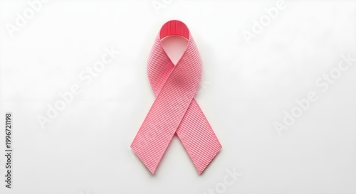 Pink ribbon symbol of breast cancer awareness on white background