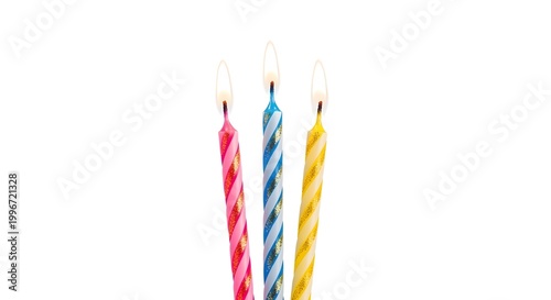 Three colorful birthday candles with burning flames isolated on white background