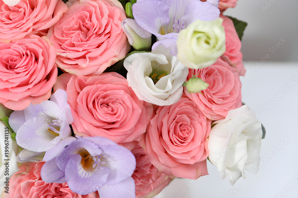 Obraz premium Elegant floral arrangement showcasing vibrant pink roses, delicate white eustoma, and fragrant purple freesias in a lush bouquet, symbolizing beauty and joy