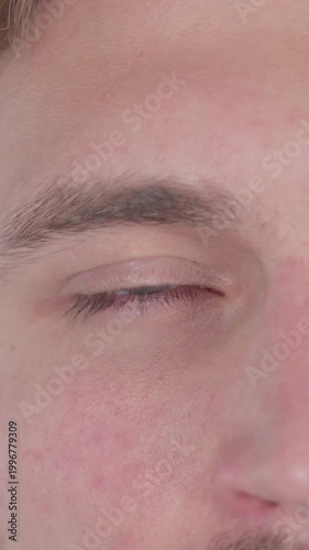 Eyes of Young Man on White Background, Vertical Video