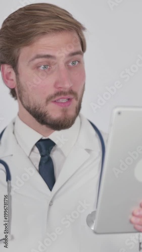 Video Call on Tablet by Young Doctor on White Background, Vertical Video