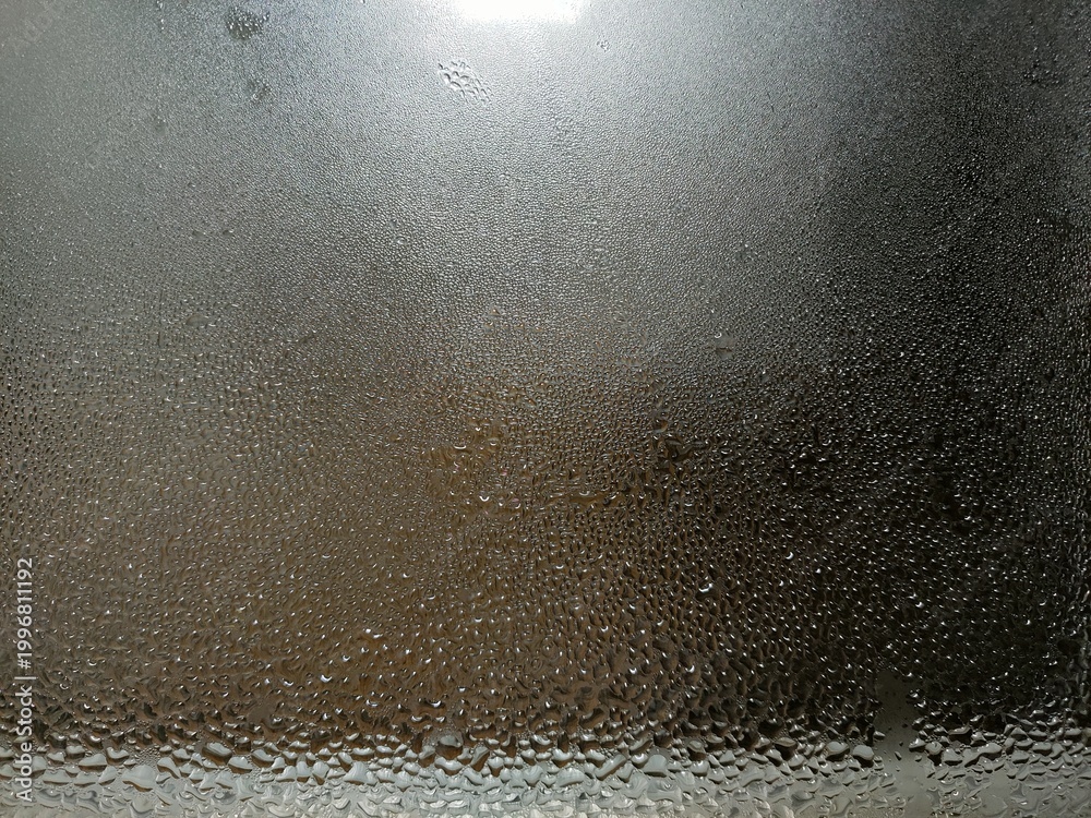 Obraz premium Foggy window, water on glass, texture of water drops on glass