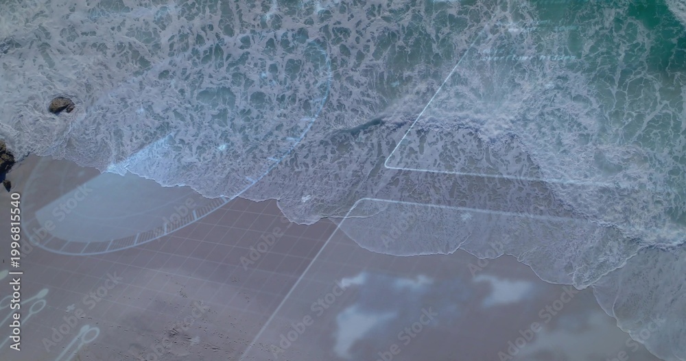 Fototapeta premium Breaking shore showing foamy surf washing onto coastal beach, with overlay and dark rock upper-left