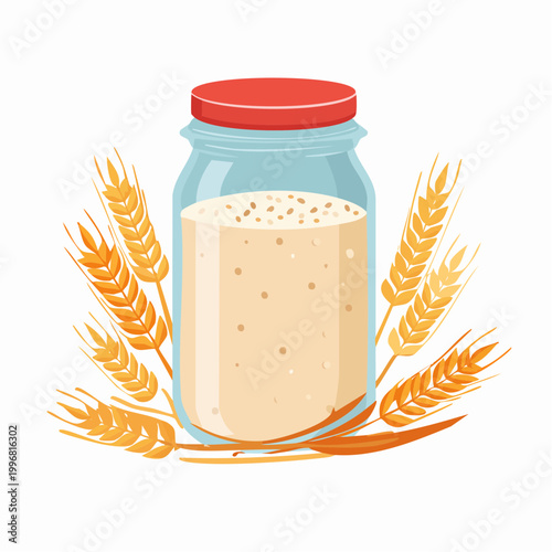 Sourdough starter in a jar with wheat stalks