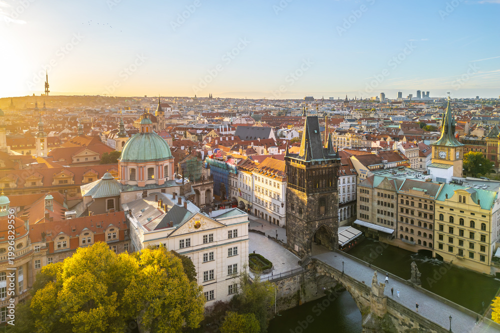 Fototapeta premium Located at Charles Bridge, the Old Town Bridge Tower stands tall against the evening sky. Its historic architecture offers a stunning view of Prague's skyline and the Vltava River below.