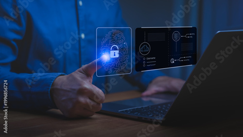 Man using laptop with virtual fingerprint scanner for cybersecurity. Biometric login technology protects digital privacy and data.