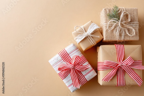 wrapped christmas gift boxes with ribbon minimal composition warm light raw photography