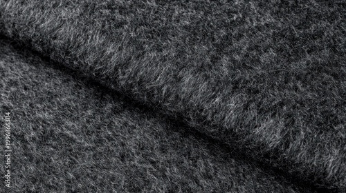 Folded dark felt fabric showcasing layered fibrous texture closeup