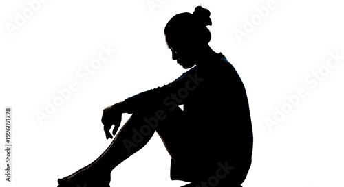 Silhouette of a sad woman sitting alone in darkness feeling depressed or anxious isolated on white background