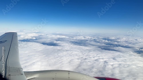 Journey Through Skies. Flying High Above Endless Clouds. Peering Through Window At Airborne Adventure Happening Outside. Experience Thrill Of Sky Travel With Detailed Aircraft View And Vast Clouds
