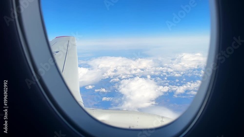 Scenic Aerial Landscape Seen From Airplane Window With Winglet, Scattered Clouds Over Land, Approaching Descent Feel, Warm Daylight, Expansive Horizon, Passenger Viewpoint