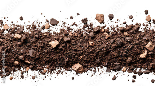 Close-up of dark soil with scattered rocks, contrasting textures against a black background