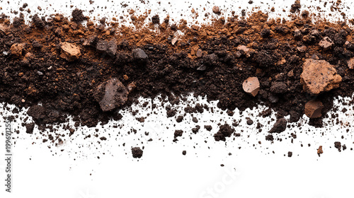 Close-up of dark soil mixed with lighter earth and small rocks against black