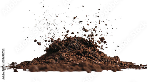 Pile of brown earth exploding with specks against a black background