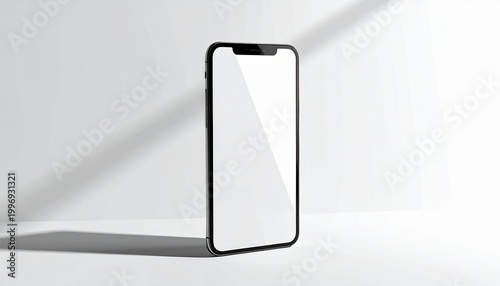 Sleek contemporary mobile device with a pristine blank display, standing upright against a minimalist white backdrop, highlighted by atmospheric light and shadow