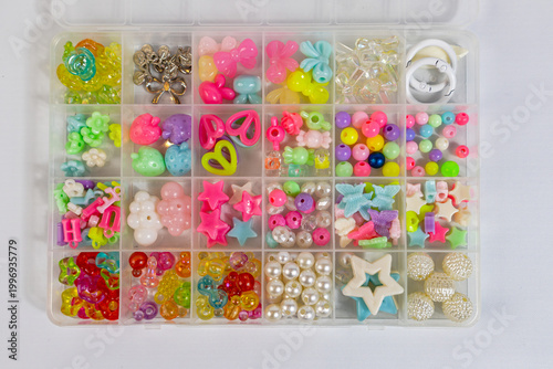 Closeup of multicolored beads in box case, craft creativity concept
