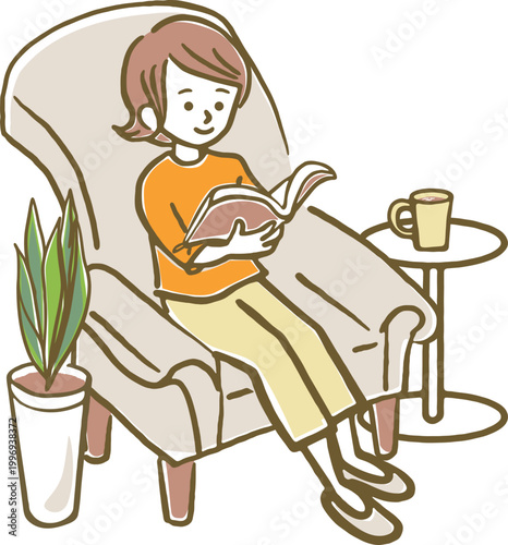 ソファーに座りくつろいだ様子で雑誌を読む女性