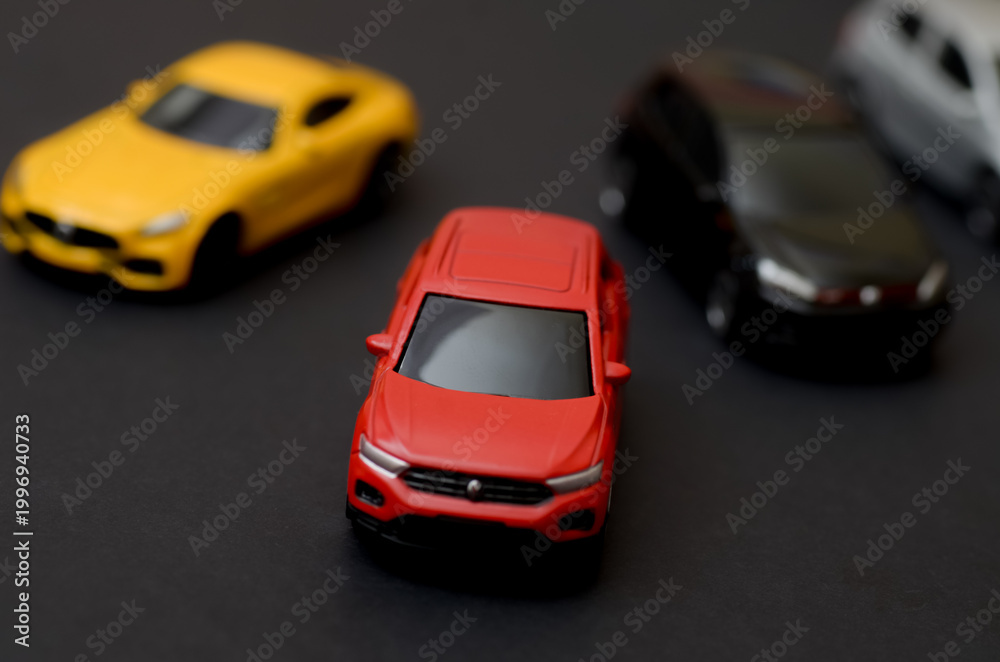 Fototapeta premium Front View of Red Crossover Model Car on Dark Surface