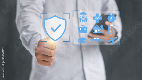 Fotografie Businessman holding smartphone with digital security shield and insurance checklist interface