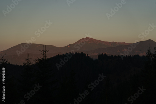 Sunset over the mountains highlighting the tranquil beauty of the landscape in the evening sky. Carpathian Mountains, Ukraine
