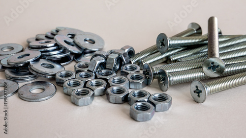 Machine Screws Nuts and Washers on White Background Close Up Hardware Set