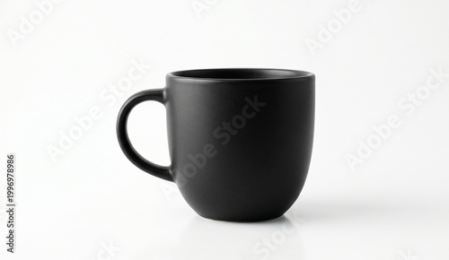 A sleek, matte black ceramic cup is captured against a pure white studio background, using soft directional lighting to emphasize its minimalist curves and granular texture.