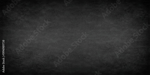 A textural study of a dark grey chalkboard, evoking a sense of mystery and depth. The subtle variations in the surface create a visually rich background.