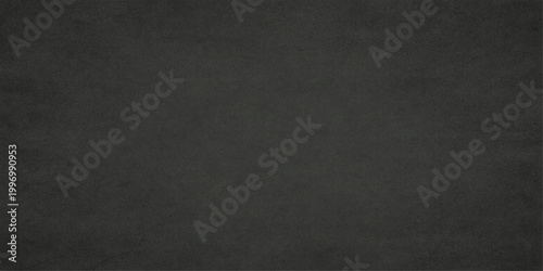 A plain, nondescript, matte black backdrop creates a blank canvas of limitless potential. The texture invites contemplation.