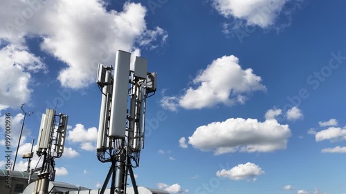 Mobile communication antenna tower against blue sky