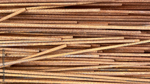 Rusty Steel Rebar Rods Stacked in Horizontal Layers, Weathered Construction Metal Texture and Industrial Background