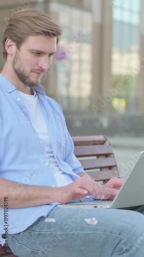 Busy Man Using Laptop Sitting Outdoor on Bench, Vertical Video