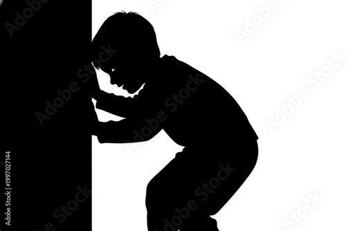 Silhouette of Curiosity: A young child, captured in silhouette, engages in an act of exploration as he peeks behind a wall, evoking a sense of innocent curiosity and wonder.