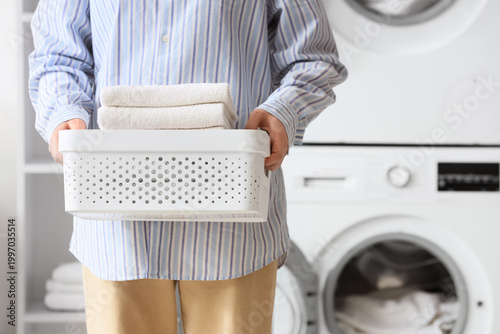 Woman with basket of towels...