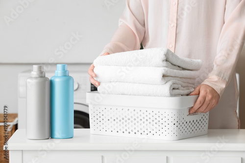 Woman with basket of clean ...