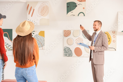 Male guide showing painting...