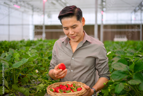 The Asian man travel at strawberry green house.