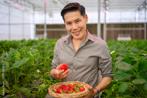 The Asian man travel at strawberry green house.