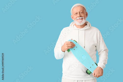 Senior man with skateboard ...